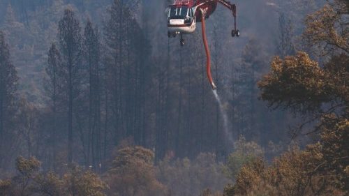 A firefighting helicopter draws water from the Klamath River to fight the McKinney Fire in the ... A firefighting helicopter draws water from the Klamath River to fight the McKinney Fire in the ...