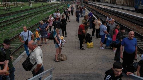 People wait at the Pokrovsk train station to leave the Donbass region, eastern Ukraine, on August 2, ...