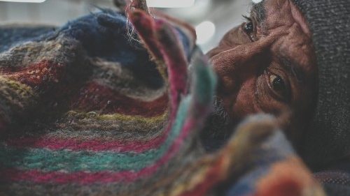 In this picture taken on January 29, 2022, shows a homeless man wrapped in a quilt sitting inside a ... In this picture taken on January 29, 2022, shows a homeless man wrapped in a quilt sitting inside a ...