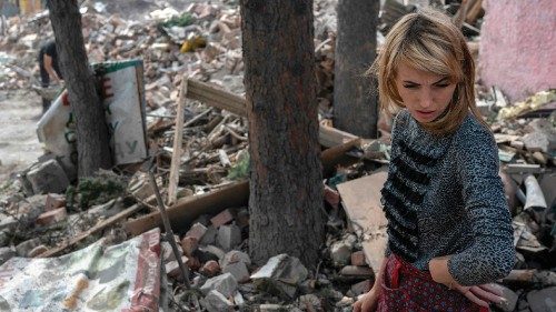 Pet shop owner Julia, 32, looks at the debris of her shop after it has been hit by Russian forces, ...