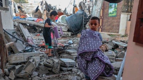 Palestinian youths salvage belongings from the rubble of their house which was destroyed during the ... Palestinian youths salvage belongings from the rubble of their house which was destroyed during the ...