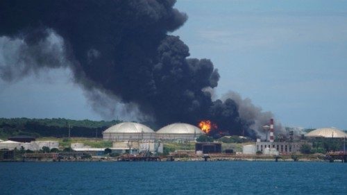 Fire is seen over fuel storage tanks that exploded near Cuba's supertanker port in Matanzas, Cuba, ...