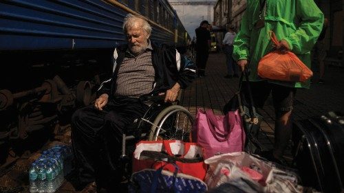 A man on a wheelchair waits to board a train to Dnipro and Lviv during an evacuation effort from ...