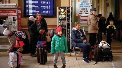 FILE PHOTO: Ukrainian refugees wait for a train to continue their journey after crossing the ...