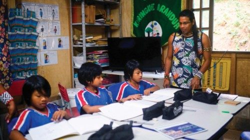 Guarani indigenous leader Vanderlei Weraxunu teaches children in a classroom at the Kyringue Arandua ...