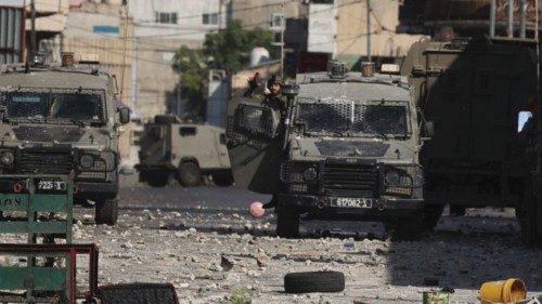 Israeli security forces vehicles take position during a raid in the old town of Nablus, in the ...