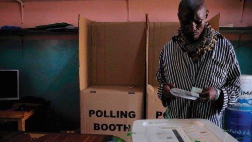 A prisoner casts his ballot at the Nakuru GK Prison polling station during Kenya's general elections ...