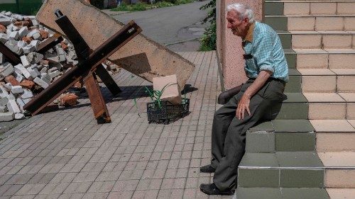 An elderly man takes a break as he comes back from a market in Bakhmut on August 4, 2022, amid the ...