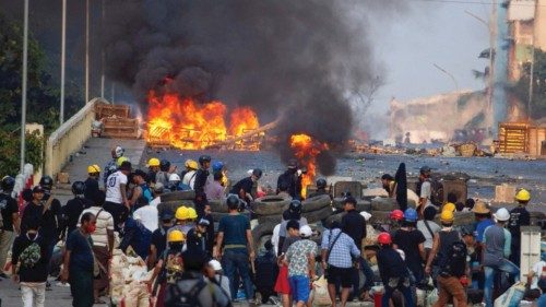 FILE PHOTO: Anti-coup protesters stand at a barricade as they clash with security forces on Bayint ... FILE PHOTO: Anti-coup protesters stand at a barricade as they clash with security forces on Bayint ...