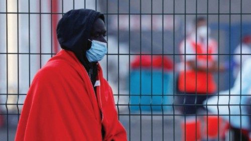 A migrant waits to be treated by the Red Cross after disembarking from a Spanish coast guard vessel, ...