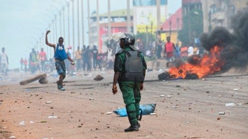 (FILES) In this file photo taken on July 28, 2022 A police officer looks on as protesters block ...