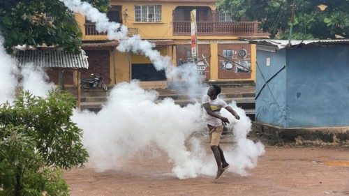 A demonstrator throws a gas canister during an anti-government protest, in Freetown, Sierra Leone, ...