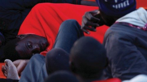 Migrants wait to disembark from a Spanish coast guard vessel, in the port of Arguineguin, in the ...