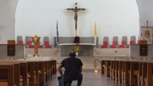 A man kneels down at the Metropolitan Cathedral of the Immaculate Conception of Mary as the ...