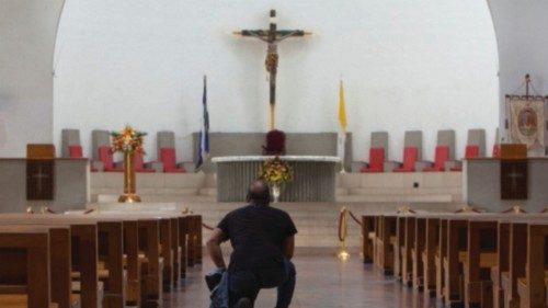 A man kneels down at the Metropolitan Cathedral of the Immaculate Conception of Mary as the ... A man kneels down at the Metropolitan Cathedral of the Immaculate Conception of Mary as the ...