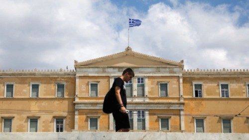 A man makes his way in front of the Greek parliament building in Athens, Greece, August 8, 2022. ... A man makes his way in front of the Greek parliament building in Athens, Greece, August 8, 2022. ...