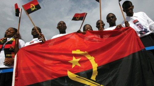 FILE PHOTO: Resident students from Angola wave national flags as Angola's President Jose Eduardo Dos ...