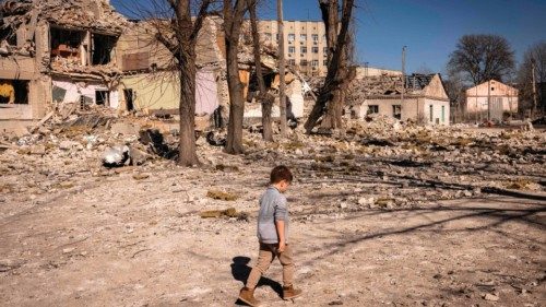 A children walks in front of a damaged school in the city of Zhytomyr, northern Ukraine, on March ...