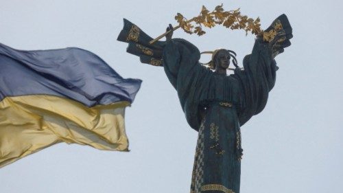 A Ukrainian national flag waves in front of the Independence Monument in the centre of Kyiv, as ...