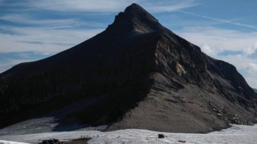 This picture taken on August 6, 2022, above the resort of Les Diablerets shows hikers walking on the ... This picture taken on August 6, 2022, above the resort of Les Diablerets shows hikers walking on the ...