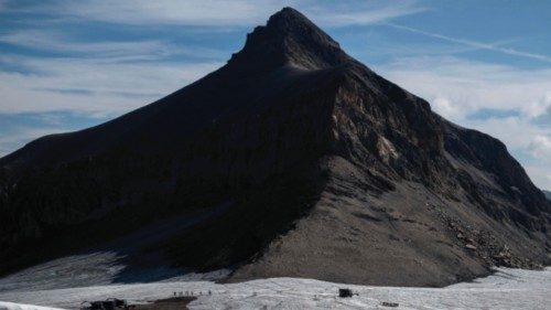 This picture taken on August 6, 2022, above the resort of Les Diablerets shows hikers walking on the ...