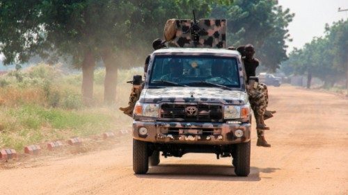 Nigerian Army soldiers are seen driving on a military vehicle in Ngamdu, Nigeria, on November 3, ...