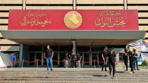 Supporters of Iraqi Shiite cleric Muqtada al-Sadr stand outside the Iraqi parliament in the Green ...