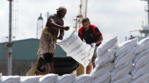 Workers stack imported sacks of fertilizer onto a truck at the port of Colombo on August 22, 2022. ...