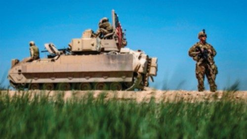 (FILES) In this file photo taken a US soldier stands guard next to a US Bradley Fighting Vehicle ...
