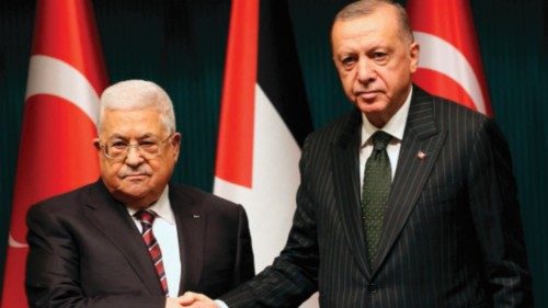 Turkey's President Recep Tayyip Erdogan (R) shakes hands with Palestinian President Mahmoud Abbas ...