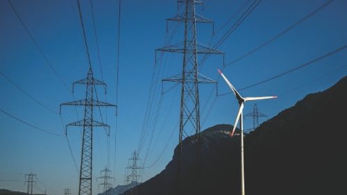A wind turbine is seen next to electricity pylons near Dorenaz, western Switzerland on August 23, ...