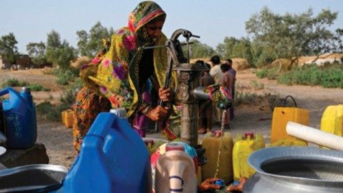 In this picture taken on May 11, 2022, a woman fills cans with water from a hand pump during a ... In this picture taken on May 11, 2022, a woman fills cans with water from a hand pump during a ...