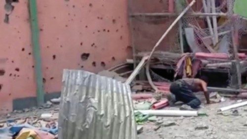 A man crouches to inspect a damaged playground following an air strike in Mekelle, the capital of ...