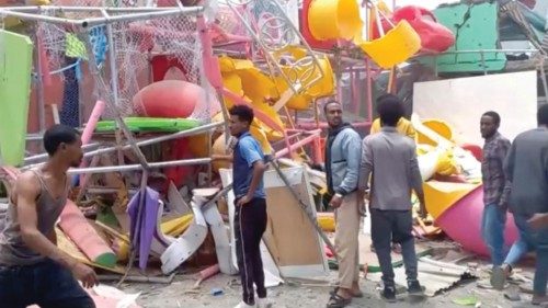 People inspect a damaged playground following an air strike in Mekelle, the capital of Ethiopia's ...