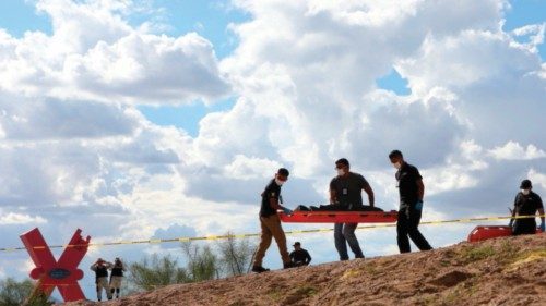 Forensic experts carry the body of a Guatemalan migrant girl who drowned while trying to cross with ...