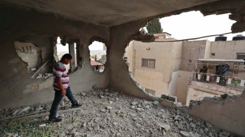 People inspect the flat of Raad Hazem, a Palestinian who had carried out a dead shooting attack in ...