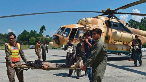 Pakistan's army soldiers carry a stranded local tourist on a stretcher from a army helicopter after ...