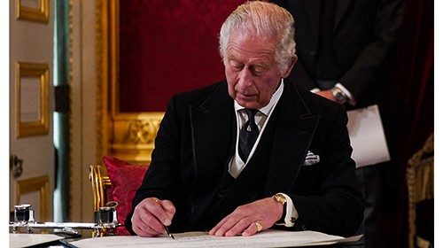 Britain's King Charles III signs an oath to uphold the security of the Church in Scotland, during a ...