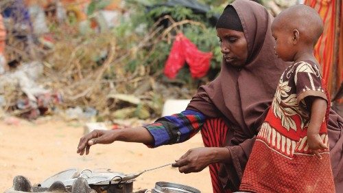 FILE PHOTO: Kadija Mohamed cooks food for her children in a camp set up for internally displaced ...