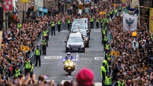 Members of the public gather along the Royal Mile to watch the hearse carrying the coffin of Queen ...