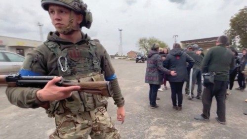 Residents greet soldiers in a location given as Kozacha Lopan, Kharkiv Region, Ukraine in this ...