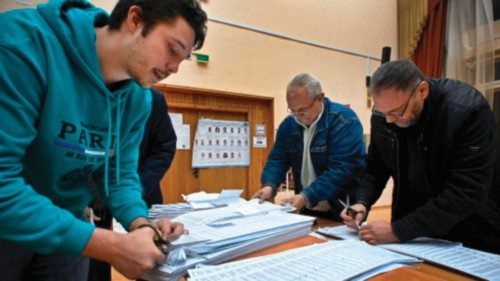 Members of a local electoral commission calculate ballots at a polling station after the last day of ...