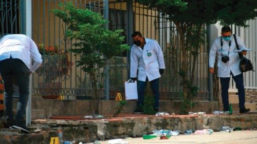 Members of the Colombian scientific police inspect outside the bar where six people were murdered by ...