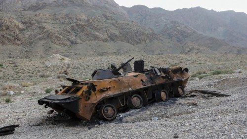 FILE PHOTO: A view shows a burnt armoured personnel carrier of Kyrgyz forces near Golovnoi water ...