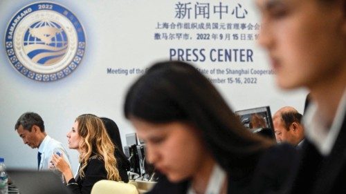 Journalists work in the Summit's press centre in Samarkand on September 15, 2022. - A regional ...