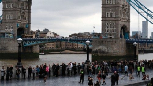 Members of the public stand in the queue on the South Bank of the River Thames, alongside Tower ...