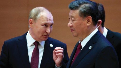 Russian President Vladimir Putin speaks to China's President Xi Jinping during the Shanghai ...