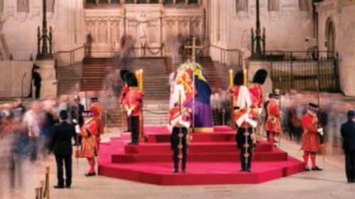 A long exposure photograph shows members of the public as they file past the coffin of Queen ...