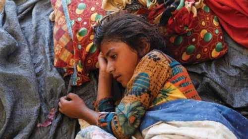 Displaced and a malaria patient girl lies down, as she takes refuge with her family in a camp, ...