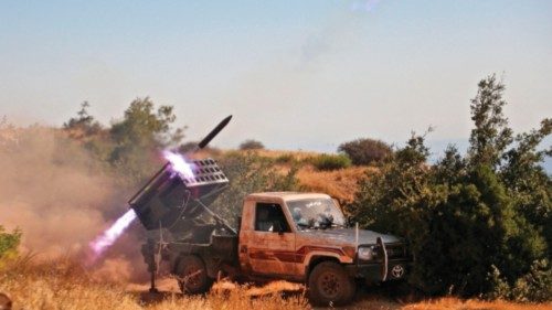 TOPSHOT - Syrian rebel fighters launch rockets from Jabal al-Turkman in the western countryside of ...